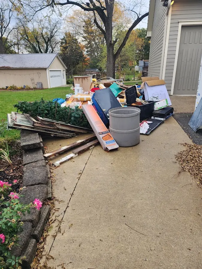 Dumpster being loaded with debris for Estate Cleanout Dumpster Rental in Gering